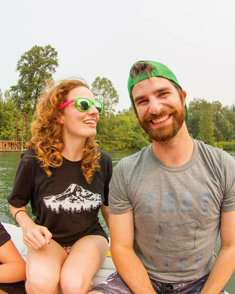 Two people wearing Oregon graphic tees together on the river