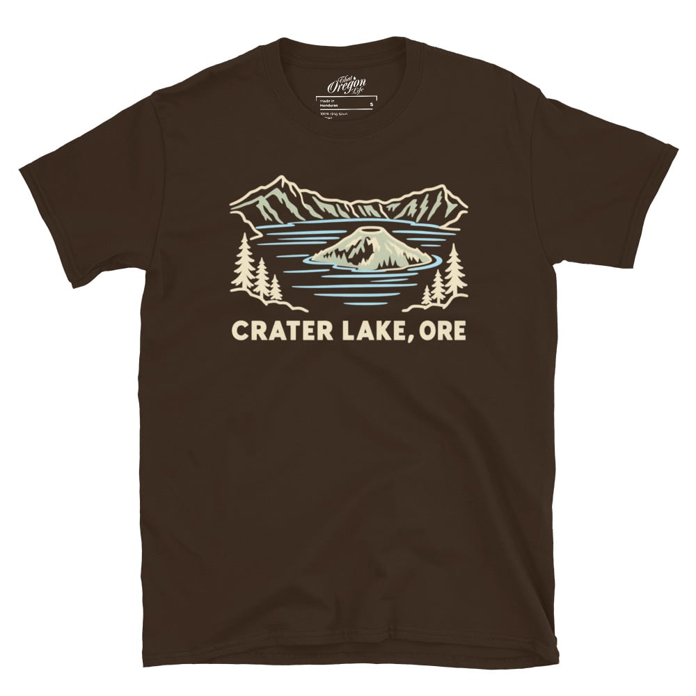 Dark Chocolate Crater Lake Oregon tee with pale line art of Wizard Island, mountains, evergreen trees, and CRATER LAKE, ORE lettering.