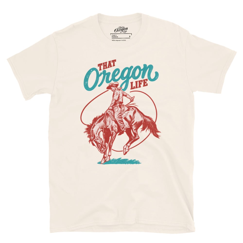Natural cream Oregon Cowboy T-Shirt with distressed red and turquoise That Oregon Life lettering and a cowboy riding a bucking horse
